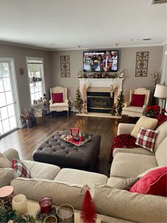 a living room filled with furniture and a flat screen tv mounted on the wall above a fireplace