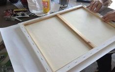 a person is working on an unfinished piece of art with plywood and glues