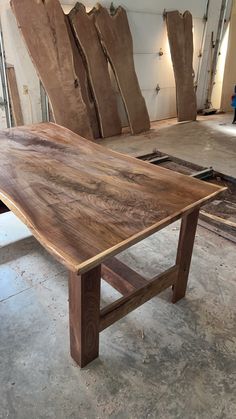 a wooden table sitting on top of a hard wood floor next to other pieces of furniture