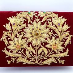 a red velvet purse with gold embroidered flowers on it