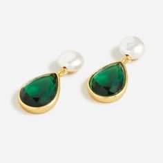 two pairs of earrings with green tears and pearls on the end of each ear