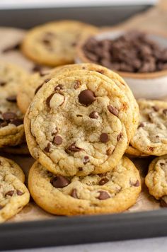 a pile of chocolate chip cookies sitting on top of a table