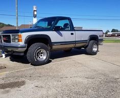 a gray truck parked in a parking lot