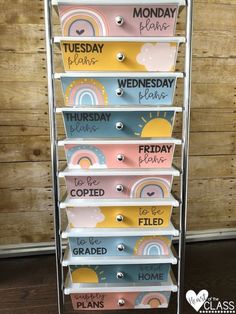 a metal rack with several different colored boxes on it and the words monday, wednesday, friday