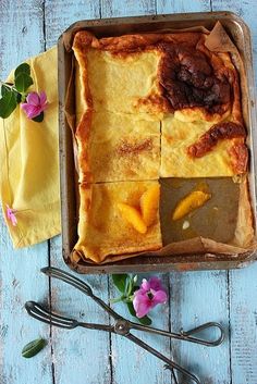 a pie sitting on top of a wooden table next to scissors