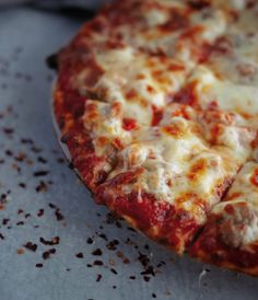 a close up view of a pizza with cheese and meat on it's crust