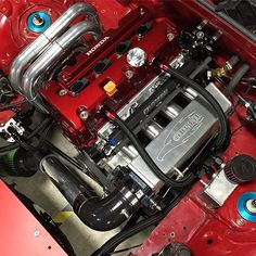 the engine compartment of a red sports car