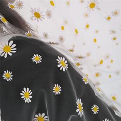 the back of a woman's dress with daisies on it and yellow dots