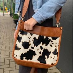 Brown And Cow Print Saddle Crossbody Bag Purse This Bag Measures 10.25 Inches Tall And 12 Inches Across With 3 Inch Width On The Sides. Adjustable Matching Strap And Gold Hardware. Interior Has 2 Open Pockets And 1 Zippered Pocket. Purse Has Zipper Closure. Vegan Leather Brown Satchel With Snap Closure For On-the-go, Fall Shoulder Bag With Snap Closure, Crossbody Shoulder Bag With Snap Closure For Errands, Trendy Cow Print Bags For Everyday Use, Casual Brown Crossbody Hobo Bag, Black Bag With Cow Print For Everyday Use, Fall Brown Shoulder Bag With Snap Closure, Brown Hobo Bag With Snap Closure, Leather Cow Print Bag For Everyday Use