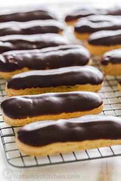 chocolate covered doughnuts cooling on a wire rack