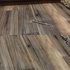 a wooden floor that has been cleaned and is laying on top of a rug with a toothbrush in it