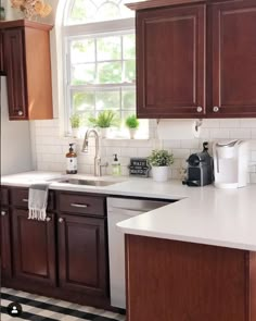 a kitchen with wooden cabinets and white counter tops, black and white checkered flooring