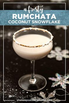 a cocktail in a coupe glass with the words rumchata coconut snowflake