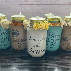 six painted mason jars with flowers and sayings on them