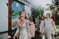 a group of women walking down a street next to each other