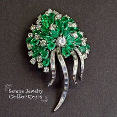 Stunning burst of vivid green emeralds and sparkly white diamonds covering all the surfaces of this beautiful platinum vintage brooch!Total Weight: 29.15 gramsSize: 2.5 inch tall, 1.5 inch widePrecious Metal: PlatinumPrecious stones:-Emeralds: QTY: 31, 2.7mmx4.7mm to 4.2mmx6.3mm size, 7.5 carats-Diamonds: 29 rounds, 20 baguettes, 6 carats Green Diamond Wedding Brooches, Vintage Green Diamond Brooches, Fine Jewelry Green Brooch For Anniversary, Elegant Green Diamond Brooch, Fine Jewelry Green Brooches For Anniversary, Green Fine Jewelry Brooch For Anniversary, Luxury Green Brooch For Anniversary, Luxury Green Brooches For Anniversary, Green Fine Jewelry Brooches For Wedding