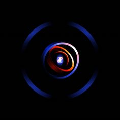 an abstract photo with blue and red circles in the center on a dark black background