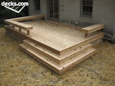 a wooden deck in front of a house