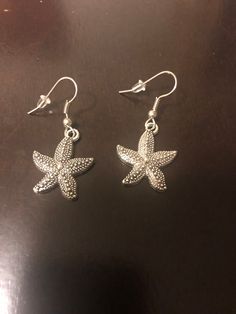 These silver earrings are beautiful starfish. The starfish are about 1 inch long.  Great gift for a loved one, that special starfish. Elegant Starfish Charm Drop Earrings, Elegant Handmade Starfish Earrings, Handmade Silver Starfish Earrings, Elegant Silver Starfish Jewelry, Nickel-free Starfish Earrings Ocean-inspired, Silver Ocean-inspired Earrings For Gifts, Handmade Ocean-inspired Star Earrings, Starfish Charm Drop Earrings As Gift, Elegant Starfish Charm Earrings As Gift