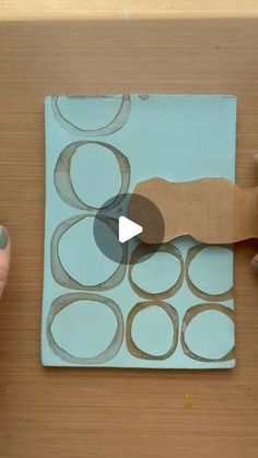 someone is cutting out circles on a piece of paper