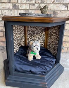 a stuffed animal sitting on top of a bed in a wooden structure with leopard print wallpaper