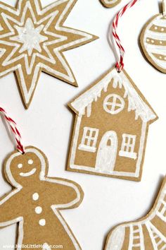 gingerbread cut out ornaments on a white table with red and white striped twine