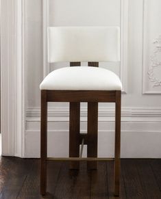 a white chair sitting on top of a hard wood floor