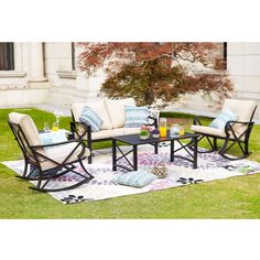 an outdoor patio furniture set sitting on top of a rug