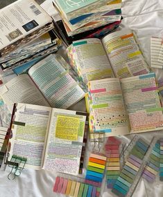 there are many different colored books on the bed