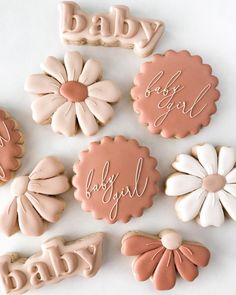 baby cookies decorated with pink and white icing are arranged in the shape of flowers