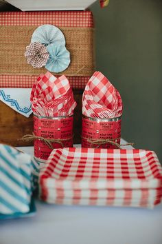 two red and white checkered napkins sitting next to each other on a table