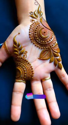 a woman's hand with henna on it