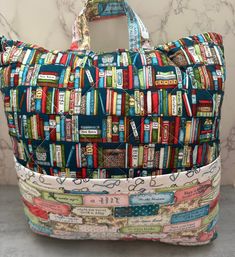 a bag made out of books is sitting on the floor next to a marble wall