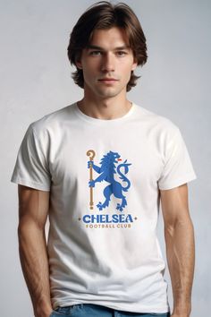 a man wearing a white chelsea t - shirt with a blue lion on the front