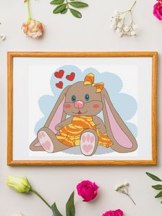 a cross stitch bunny sitting on the ground with flowers around it and hearts in the background