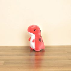 a small stuffed animal sitting on top of a wooden floor