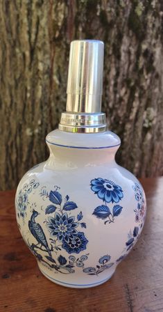 a blue and white vase sitting on top of a wooden table