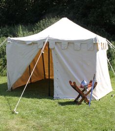 a tent with two chairs in front of it