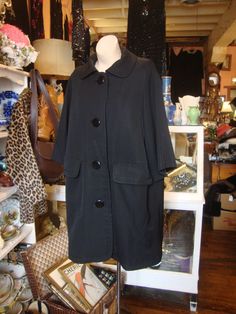 "This is a fabulous Christian Dior coat from the early 1960's. It's done in a fine gabardine, with a crepe lining.  It features a rounded collar, dropped shoulder line with bracelet sleeves, and large pockets and a 4 button closure.  It has a wonderful oversize shape.  This coat is in great shape, but could brighten up with a cleaning.  No issues found.  Here's a chance to wear a great piece of fashion history!  Comes from a smoke free home. Measurements:  Bust:  44\"   Waist:  44\"   Hip:  44\"   Across Shoulder:  16.5\"   Sleeve Length:  18.5\"   Length:  37.5\"   Please ask me any questions you may have before buying as this is a final sale. Please know your measurements and allow for movement.  I ship within 3 business days of cleared payment, usually sooner.  If you need something qui Vintage Outerwear With Covered Buttons For Spring, Vintage Spring Outerwear With Covered Buttons, Vintage Long Coat For Evening, Chic Vintage Spring Outerwear, Vintage Outerwear With Covered Buttons For Work, Retro Evening Outerwear For Fall, Retro Fall Evening Outerwear, Vintage Evening Outerwear With Buttons, 60s Clothing