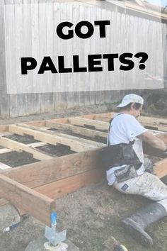 a man sitting on top of wooden pallets with the words got pallets?