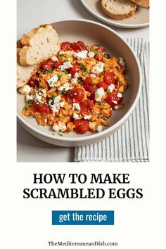 two bowls filled with scrambled eggs on top of a table next to toasted bread