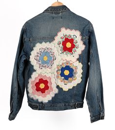 Our one of a kind upcycled patchwork jackets add power to the classic jean jacket. Stand out amongst the crowd, and take one home today! This jacket is a classic heavy denim jacket. There are four hexagon flower blocks as patches on the jacket. Size: Medium Armpit to Armpit: 21.5" Shoulder to waist in front: 24" Waist: 38" Care Instructions: Spot clean when possible. Wash inside out with cold water and lay flat to dry. Retro Cotton Patchwork Denim Jacket, Retro Cotton Denim Jacket With Patchwork, Retro Patchwork Denim Jacket, One Home, Patchwork Jacket, Classic Jeans, Lay Flat, Jean Jacket, Cold Water