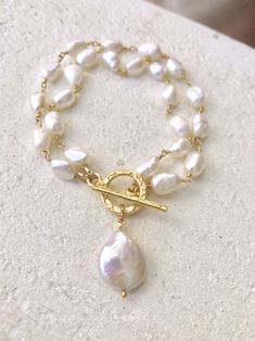 A stunning bracelet for that special someone with freshwater pearls, gold hammered toggle and coin pearl charm. Luxury Round Bracelets With Pearl Charm, Luxury Handmade Adjustable Pearl Bracelet, Coin Pearl Bracelet, Emerald Coast, Special Someone, Coin Pearls, Freshwater Pearl Bracelet, Pearl Charms, Bracelet Crafts