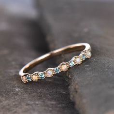 This is a Lab created Alexandrite and Lab created opal Wedding Band in 925 sterling silver. Stones: 1.5mm round cut Lab treated alexandrite ,about 0.33ct + 1.5mm Lab created Opal. Band Width: approx 1.8mm. This ring is marked 925 I accept custom making order.Please contact me if you need this service. This ring is closed ring.If you want a matching band,you can ask me custom make it. For all the jewelries,there is a 14 days money back guarantee.You can return it in the time frame without any que Dainty Opal Round Band Wedding Ring, Fine Jewelry Stackable Opal Ring For Anniversary, Stackable Opal Ring For Anniversary, Fine Jewelry, Opal Birthstone Stackable Wedding Rings, Opal Stackable Birthstone Rings For Wedding, Opal Birthstone Stackable Rings For Wedding, Stackable Round Opal Promise Ring, Opal Stackable Rings For Anniversary, Opal Gemstone Stackable Rings For Anniversary