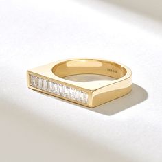 The Baguette Diamond Bar Ring is a remarkable piece of jewelry, designed to make a statement with its elegant and bold design. Crafted from 14k solid gold, this ring features a striking rectangular bar at the top, adorned with a row of channel-set baguette-cut diamonds. Features * Made to Order. * Gold KT: 10K, 14K, 18K * Width of Band: 3.70MM * Width of Top: 4.07x20.26MM * Thickness of Band: 1.18MM * Custom Gold Color: Rose Gold, Yellow Gold, White Gold * Diamond Color- Clarity: D-E-F color VVS clarity (excellent ideal cut) *Total Ctw: 0.60 ctw * Ready to Ship in 5-7 Business Days ✓ We care about the environment,the jewelry we cast is made with recycled gold. We source exclusively post-consumer material that is refined back to their pure elements to ensure that the gold is in the same qua Pinky Rings For Women, Gold Bar Ring, Channel Set Diamond Ring, Ring Rectangle, Pinky Signet Ring, Pinky Rings, Diamond Signet Ring, Vintage Gold Rings, Statement Rings Diamond