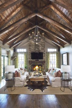 a living room filled with furniture and a fire place in the middle of a room