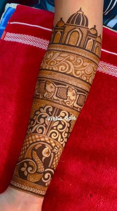 a woman's arm with henna tattoos on it