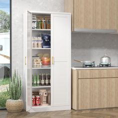 an open cabinet in a kitchen next to a window