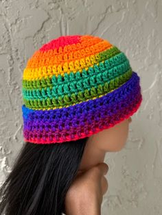 a woman wearing a multicolored crocheted hat