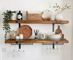 two wooden shelves with wine glasses, plates and utensils